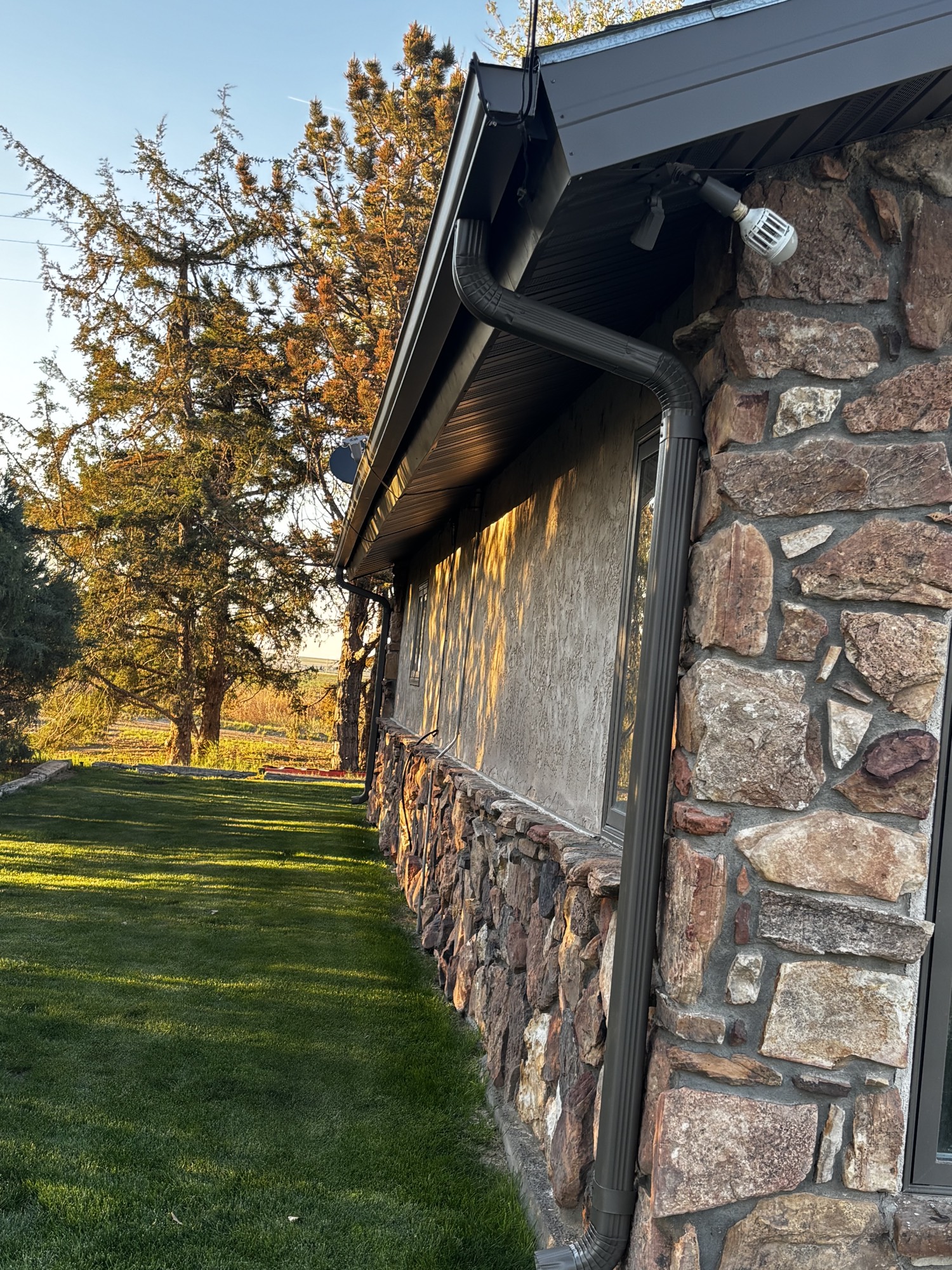 Soffit, fascia and seamless gutters on stone house